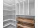 Spacious walk-in closet with custom white shelving, storage nooks and pull-out wooden drawers at 481 Woodland Shores Rd, Charleston, SC 29412