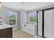 Bright bathroom featuring a soaking tub, sleek glass shower, and dual windows for natural light at 482 Sanders Farm Ln, Wando, SC 29492