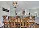 Dining room featuring modern light fixtures, hardwood floors, and views into the kitchen at 482 Sanders Farm Ln, Wando, SC 29492