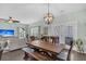 Open-concept dining room boasts a wooden table, modern lighting, and seamless access to the cozy living area at 482 Sanders Farm Ln, Wando, SC 29492