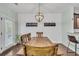 Dining room featuring modern light fixtures, hardwood floors, and access to the back yard at 482 Sanders Farm Ln, Wando, SC 29492