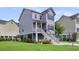 Exterior shot of a three-story home with a front porch and well-manicured lawn at 482 Sanders Farm Ln, Wando, SC 29492