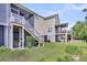 Exterior view of a three-story home with double porches and outdoor entertainment spaces at 482 Sanders Farm Ln, Wando, SC 29492
