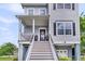 Inviting front entrance with a charming door wreath, potted plants, and elevated porch at 482 Sanders Farm Ln, Wando, SC 29492