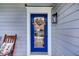 Charming blue front door with a glass panel and seasonal wreath at 482 Sanders Farm Ln, Wando, SC 29492