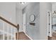 Upstairs hallway with hardwood flooring and a decorative mirror at 482 Sanders Farm Ln, Wando, SC 29492