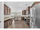 Modern kitchen featuring stainless steel appliances, granite countertops, and dark wood cabinets at 482 Sanders Farm Ln, Wando, SC 29492