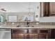 Modern kitchen featuring granite counters, stainless steel appliances, and dark wood cabinets at 482 Sanders Farm Ln, Wando, SC 29492