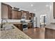 Open kitchen featuring stainless steel appliances, hardwood floors, and granite countertops at 482 Sanders Farm Ln, Wando, SC 29492