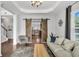 Stylish living room with hardwood floors, tray ceilings, and decorative sliding barn doors to kitchen at 482 Sanders Farm Ln, Wando, SC 29492