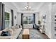 Comfortable living room with tray ceiling, large window, and a functional desk space at 482 Sanders Farm Ln, Wando, SC 29492