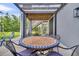 Covered patio with a table and chairs, perfect for entertaining at 482 Sanders Farm Ln, Wando, SC 29492