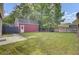 Large backyard with a well-maintained lawn and a detached garage at 4856 Cane Pole Ln, Summerville, SC 29485