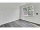 Bright bedroom with a window letting in natural light and gray wood-look flooring at 4856 Cane Pole Ln, Summerville, SC 29485