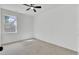 Bright bedroom featuring a ceiling fan, a window with backyard view, and neutral carpeting at 4856 Cane Pole Ln, Summerville, SC 29485