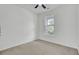 Bright bedroom featuring a ceiling fan, a large window, and neutral carpeting at 4856 Cane Pole Ln, Summerville, SC 29485