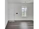 Inviting entryway featuring modern gray floors, white trim, and ample natural light showcasing a welcoming ambiance at 4856 Cane Pole Ln, Summerville, SC 29485
