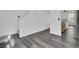 Entryway featuring gray wood-look flooring leading to the kitchen and stairs at 4856 Cane Pole Ln, Summerville, SC 29485