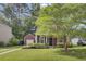 Charming home featuring a lush front lawn, mature landscaping, and a detached garage at 4856 Cane Pole Ln, Summerville, SC 29485
