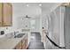 Bright kitchen featuring stainless steel appliances, wood cabinets, and gray wood-look flooring at 4856 Cane Pole Ln, Summerville, SC 29485