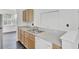 Bright kitchen features a double sink, light wood cabinets, ample counter space and all white appliances at 4856 Cane Pole Ln, Summerville, SC 29485