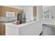 Well-equipped kitchen features light wood cabinets, stainless steel appliances, and a convenient breakfast bar overlooking the living area at 4856 Cane Pole Ln, Summerville, SC 29485