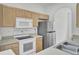 Clean kitchen featuring light wood cabinets, stainless steel appliances, and a double sink with a modern faucet at 4856 Cane Pole Ln, Summerville, SC 29485