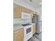 Modern kitchen featuring wood cabinets, stainless steel refrigerator, and white appliances at 4856 Cane Pole Ln, Summerville, SC 29485