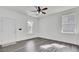 Bright living room with modern gray floors, white trim, and large windows creating a light and airy atmosphere at 4856 Cane Pole Ln, Summerville, SC 29485