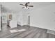 Open-concept living room featuring modern gray flooring, recessed lighting, and a ceiling fan for a bright and airy feel at 4856 Cane Pole Ln, Summerville, SC 29485