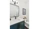 Modern bathroom with sleek vanity, black accents, a large mirror, and contemporary fixtures at 5 Addison St, Charleston, SC 29403