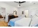 Bright, airy bedroom features hardwood floors, ceiling fan, natural light, king bed and an ensuite at 5 Addison St, Charleston, SC 29403