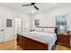 Cozy bedroom boasts wood floors, ceiling fan, natural light, and a king bed with stylish bedding at 5 Addison St, Charleston, SC 29403