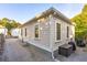 Back of house shows siding, foundation, and backyard gravel at 5 Addison St, Charleston, SC 29403