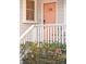 Close-up of the home's front door with fresh flowers, creating a welcoming entrance and charming curb appeal at 5 Addison St, Charleston, SC 29403