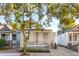 Inviting single-story home featuring a cozy front porch, tidy landscaping, and a welcoming front entrance at 5 Addison St, Charleston, SC 29403