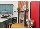 This kitchen features teal cabinets, stainless steel appliances, and a cozy fireplace with decorative accents at 5 Addison St, Charleston, SC 29403