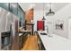 Stylish kitchen with stainless steel appliances, large island with sink, and elegant green cabinetry at 5 Addison St, Charleston, SC 29403