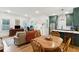 Spacious living room with a dining table and a glimpse into the well-equipped kitchen at 5 Addison St, Charleston, SC 29403