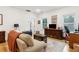 Bright living room featuring hardwood floors, white walls, and comfortable seating at 5 Addison St, Charleston, SC 29403