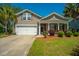 Charming single-Gathering home featuring a two-car garage, covered porch, and beautifully landscaped front yard at 5008 Bowles Dr, Summerville, SC 29485
