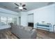 Inviting living room with a ceiling fan, crown molding, and modern decor on wood-look flooring at 5008 Bowles Dr, Summerville, SC 29485