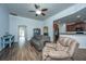 Cozy living room featuring hardwood floors, comfortable seating, and an open layout to the kitchen and dining areas at 5008 Bowles Dr, Summerville, SC 29485