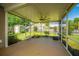 Spacious screened porch with ceiling fan, offering a great view of the fenced backyard and surrounding greenery at 5008 Bowles Dr, Summerville, SC 29485