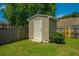 Backyard storage shed near a wooden fence, with a well-maintained lawn at 5008 Bowles Dr, Summerville, SC 29485