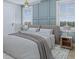 Calming bedroom featuring wainscoting, ceiling fan, and neutral decor for a serene retreat at 5213 Seewee Rd, Awendaw, SC 29429