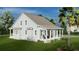 Beautiful home with a classic design, featuring a inviting porch and well-manicured lawn at 5213 Seewee Rd, Awendaw, SC 29429