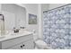 Well lit bathroom features a shower with a blue patterned curtain and classic painting at 523 Fern Tree Dr, Summerville, SC 29486