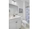 Well lit bathroom features a shower with a blue patterned curtain and classic painting at 523 Fern Tree Dr, Summerville, SC 29486