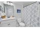 Well-lit bathroom with a modern vanity, toilet, and shower featuring a decorative shower curtain at 523 Fern Tree Dr, Summerville, SC 29486